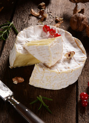 Camembert cheese on a rustic background