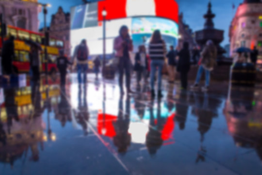 Defocused blur of lights, people and reflections at night in Piccadilly Circus, London 