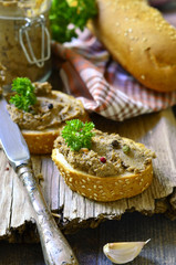 Pate from beef liver in a jar with bread slice.