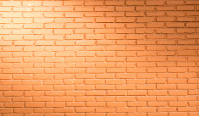 red brick wall background with light from corner