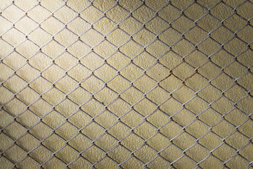 steel wire mesh fence wall background with light from corner