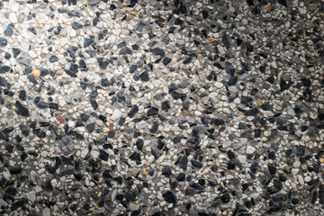 black sand stone wall background texture with light from corner