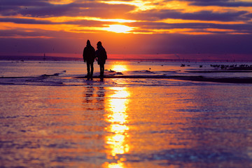 Young couple is watching sunset