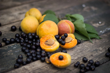 Naklejka na ściany i meble fresh apricots, black currant in a glass bowl transparent scatte