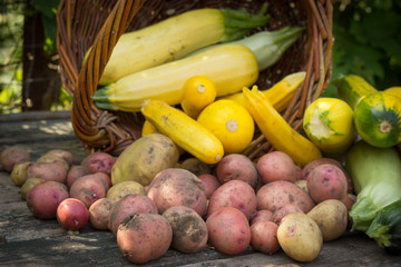 yellow, green zucchini, potatoes, stained ground on old wooden t