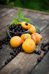 fresh apricots, black currant in a glass bowl transparent scatte