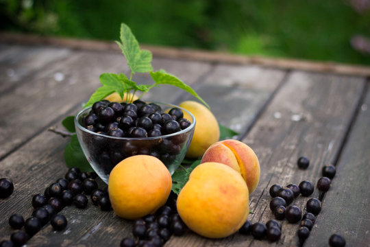 fresh apricots, black currant in a glass bowl transparent scatte