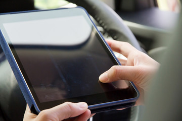 Woman Sitting in the Car and Using digital tablet