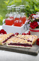 Cherry pie and cherry juice at the table