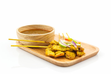 Grilled pork satay with peanut sauce.
