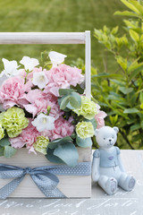 Wooden box with pink and yellow carnations