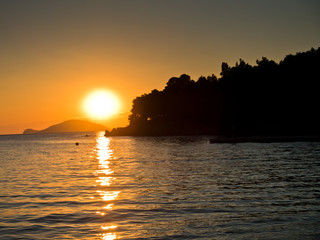 Sunset with small pier and turtle island in background,Sithonia