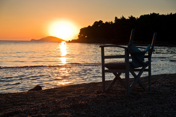 Beach with small director like chair at sunset in Sithonia