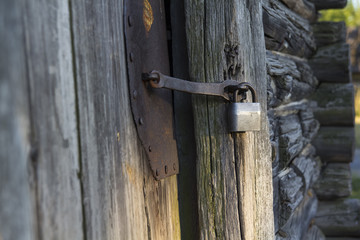 Old house. Door closed on the padlock