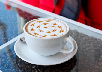Hot coffee with heart pattern in white cup