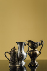 Fototapeta na wymiar antique metal kettle on a yellow background