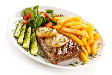 Grilled steak, French fries and vegetables 
