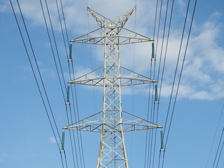 electric high voltage power post with blue sky.