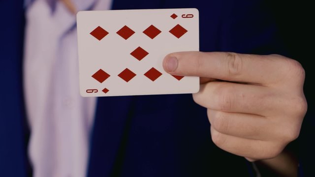 Hands magician show a trick with cards