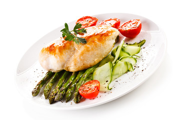 Roast chicken fillet and vegetables on white background 