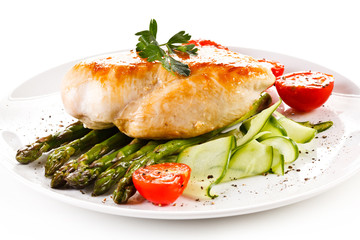 Roast chicken fillet and vegetables on white background 