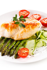 Roast chicken fillet and vegetables on white background 