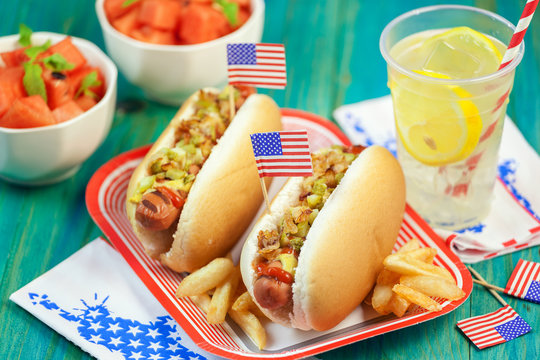 American hot dog with pickles, fried onions, ketchup, mustard and Lemonade at a Picnic for 4th of July