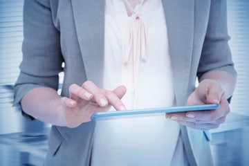 Composite image of close up of woman using tablet