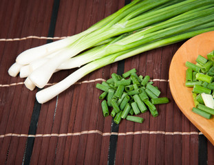 Chopped green onions on a wooden