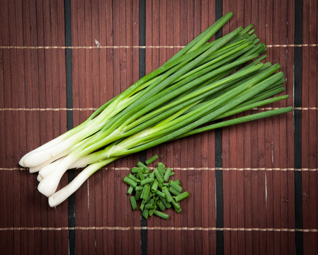 Chopped green onions on a wooden