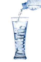 pouring water in an elegant tall glass with ice and water drops on white background