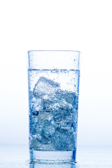 elegant glass with water and ice on a white background