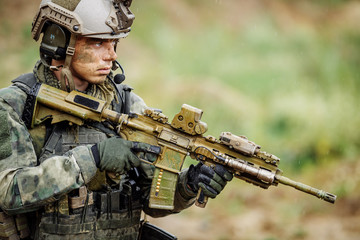 Portrait of a soldier in the battlefield with a rifle