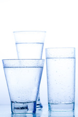 three elegant glass of water and reflection