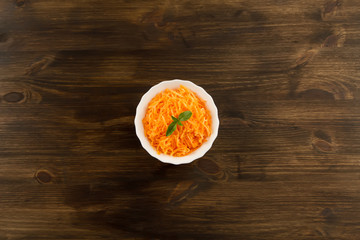 Bunch of fresh carrots with green leaves on wooden . Cooking carrot salad. Healthy vegetarian food