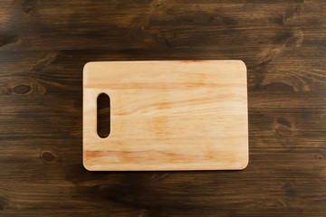 Cutting board on wooden background