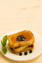 fresh french toast with honey and jam on a white plate with berries. healthy diet