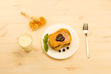 fresh french toast with honey and jam on a white plate with berries. healthy diet