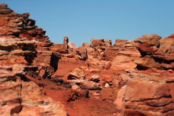 Red rocky outcrop and blue ocean at Broome Western Australia 2008