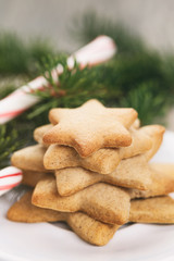star cookies and candy cane on table, vintage toned