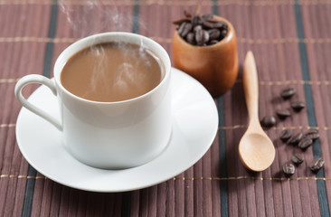 cup of coffee and Wooden Spoon on wood table