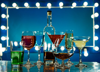 Many wine glasses with different colored drinks