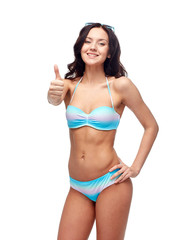 Fototapeta premium happy woman in swimsuit showing thumbs up