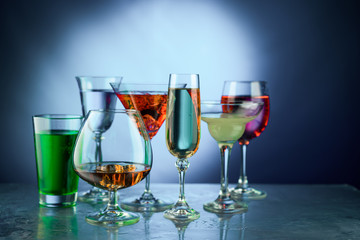 A lot of wine glasses with different alcohol