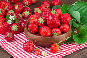 fresh strawberries on red checkered tablecloth