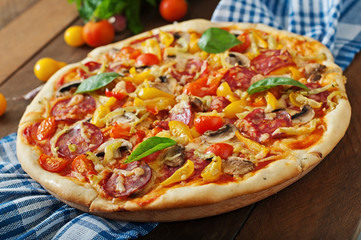 Pizza with salami, tomato, cheese and mushrooms