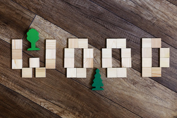 wood tree.photo feature the inscription "wood" on wooden background with wooden figures trees.