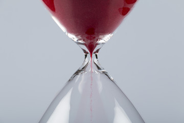 Red sand in an hourglass, horizontal