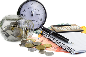 Business and finance concept.Pen,calculator,notepad and clock with money on white background.