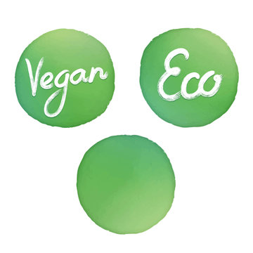 Set of three green hand drawn watercolor circle background templates isolated on white background. Handwriting brush signs: "Vegan" and "Eco". Text on separate layer.